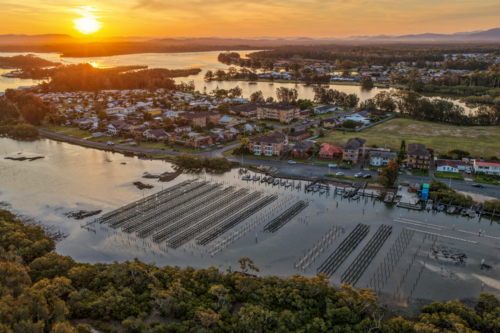 Aerial image capturing the Coolongolook River in Tuncurry at sun set - Australian Stock Image