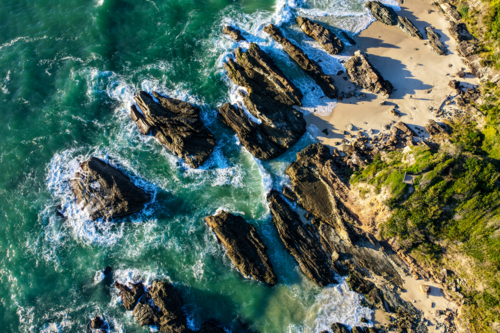 Aerial image capturing the rugged rocky coastline of Burgess Beach, Forster - Australian Stock Image