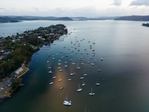 Aerial image looking south from Gosford at boats moored in Brisbane Water at dusk - Australian Stock Image