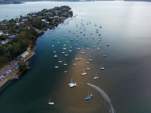 Aerial image looking south from Gosford at boats moored in Brisbane Water at dusk - Australian Stock Image
