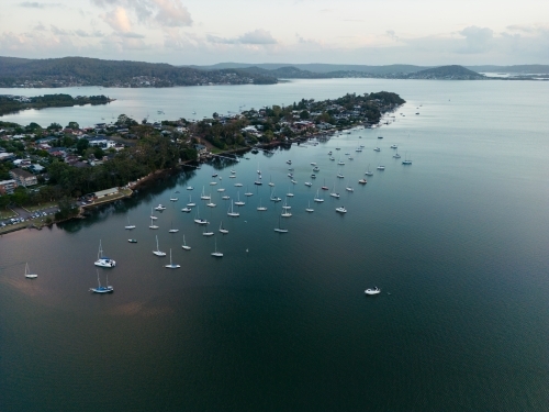 Aerial image looking south from Gosford at boats moored in Brisbane Water at dusk - Australian Stock Image