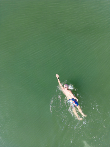 Aerial image of an open water swimmer off Suttons Beach, Redcliffe - Australian Stock Image