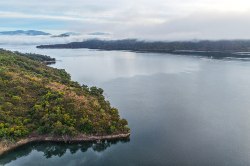 Aerial image of Glenbawn Dam and the surrounding mountain landscape with morning fog in NSW - Australian Stock Image