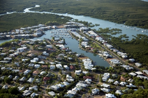 Aerial image of housing with surrounding water and bushland - Australian Stock Image