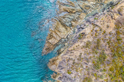 Aerial image of Hydeaway Bay, capturing its brilliant turquoise water, rocky headlands - Australian Stock Image