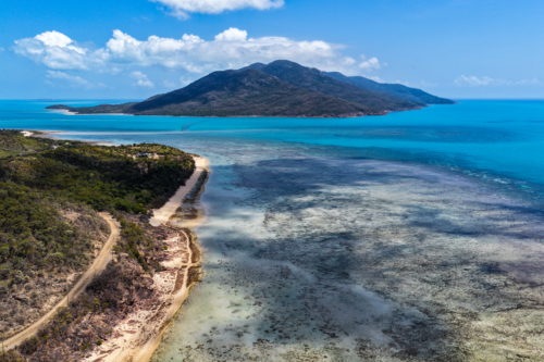 Aerial image of Hydeaway Bay, capturing its brilliant turquoise water, rocky headlands - Australian Stock Image