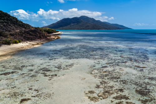 Aerial image of Hydeaway Bay, capturing its brilliant turquoise water, rocky headlands - Australian Stock Image