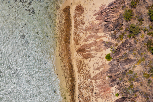 Aerial image of Hydeaway Bay, capturing its brilliant turquoise water, rocky headlands - Australian Stock Image