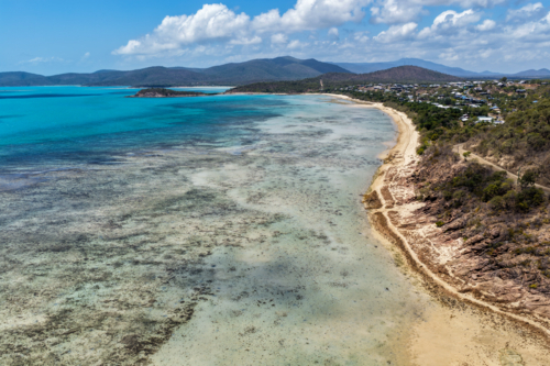 Aerial image of Hydeaway Bay, capturing its brilliant turquoise water, rocky headlands - Australian Stock Image