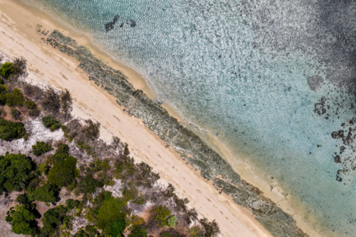 Aerial image of Hydeaway Bay, capturing its brilliant turquoise water, rocky headlands - Australian Stock Image
