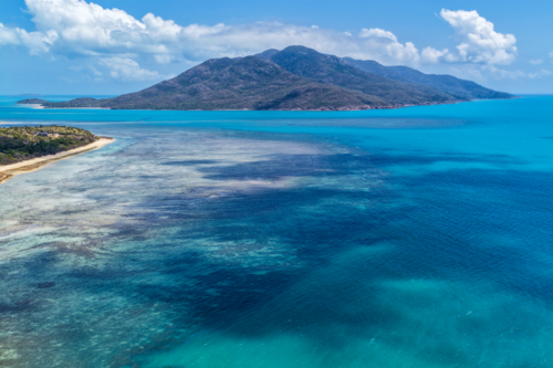 Aerial image of Hydeaway Bay, capturing its brilliant turquoise water, rocky headlands - Australian Stock Image