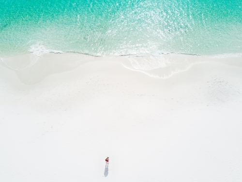 Aerial image of woman on idyllic perfect beach