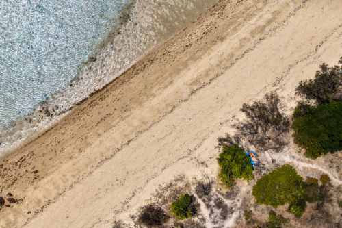 Aerial image showcasing the ocean, sandy shoreline, vegetation of Hydeaway Bay - Australian Stock Image