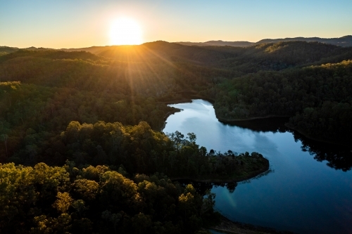 Aerial landscape of a lake surrounded by forest - Australian Stock Image