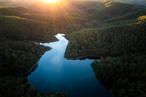 Aerial landscape of a lake surrounded by forest - Australian Stock Image