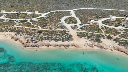Aerial of beachside campsite by the reef - Australian Stock Image