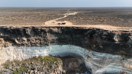 Aerial of caravan parked up at the edge of the Nullarbor cliffs - Australian Stock Image