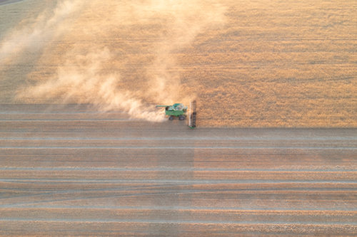 Aerial of harvester at dusk in the Wheatbelt - Australian Stock Image