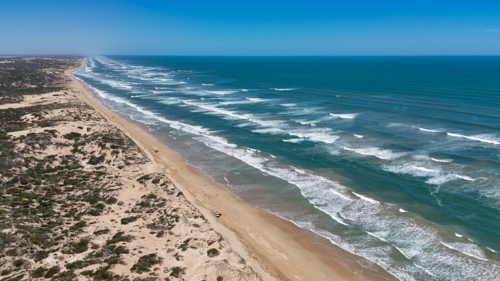 Aerial of layers of waves on a remote beach for as far as the eye can see - Australian Stock Image