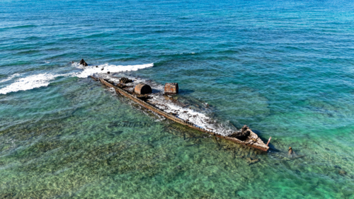 Aerial of shipwreck at the waters surface - Australian Stock Image
