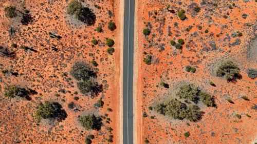 Aerial of straight road through the red outback - Australian Stock Image