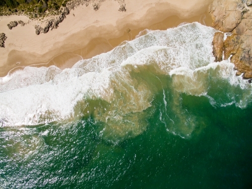 aerial of surf on sandy beach - Australian Stock Image
