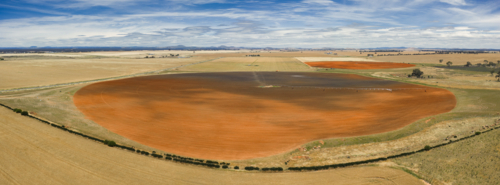 Aerial panorama view of shadows over expansive farmland and circular fields - Australian Stock Image