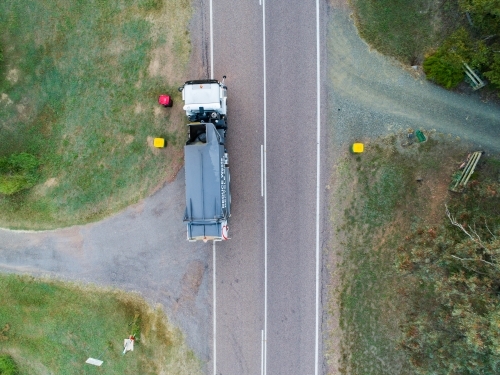 Aerial photo of garbage truck emptying bins in rural location - Australian Stock Image