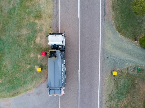 Aerial photo of garbage truck emptying bins in rural location - Australian Stock Image