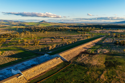 Aerial scene showcasing the Lake Keepit dam wall leading into the surrounding rural landscape - Australian Stock Image
