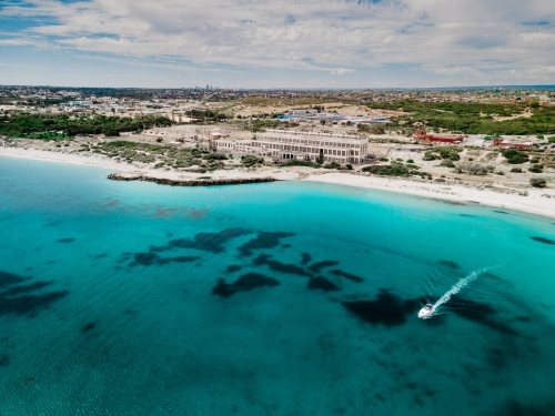 Aerial shot looking across the ocean at abandoned power station and coastline - Australian Stock Image