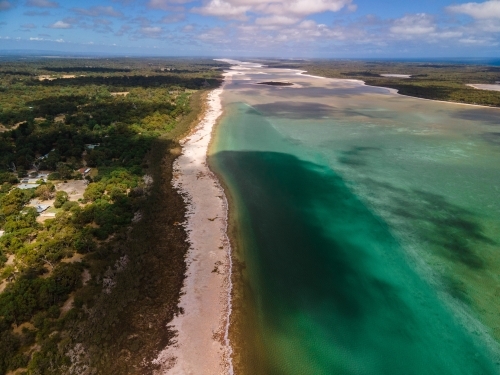 Aerial shot of a beach with an island and a shoreline - Australian Stock Image