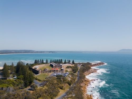Aerial shot of a coastal landscape with a building complex and tall trees - Australian Stock Image