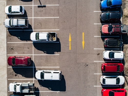 Aerial shot of cars parked in carpark with empty spaces - Australian Stock Image