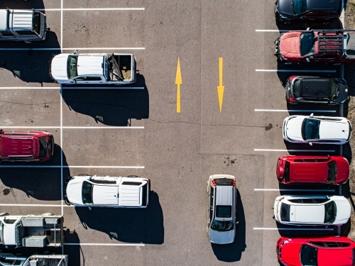 Aerial shot of cars parked in carpark with empty spaces - Australian Stock Image