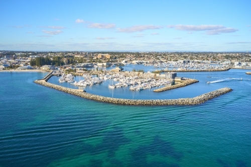 Aerial shot of Fremantle's Challenger Harbour on a sunny day with boats, yachts and groyne