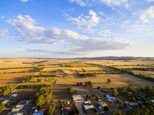 Aerial shot of farmland at the edge of a town - Australian Stock Image