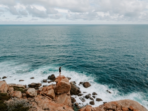 Aerial shot of man at the ocean - Australian Stock Image