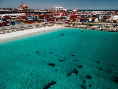 Aerial shot over the water to Fremantle Port and shipping containers