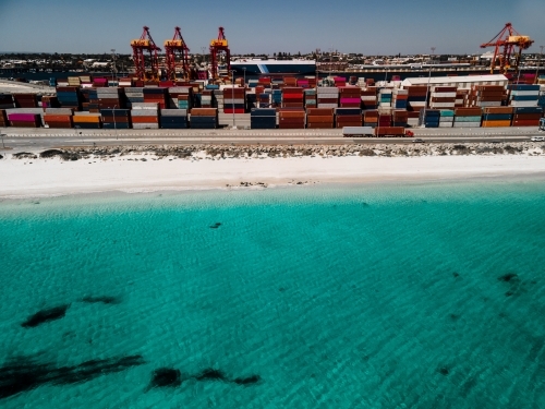 Aerial shot over the water to Fremantle Port and shipping containers