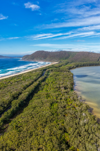 Aerial vertical scene capturing Seven Mile Beach and Wallis Lake near Forster, NSW, Australia - Australian Stock Image