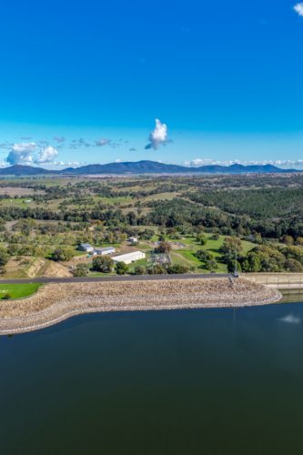 Aerial vertical view showcasing the Lake Keepit dam wall, engineering infrastructure and surrounds - Australian Stock Image
