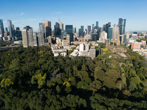 Aerial view across the Fitzroy Gardens towards buildings of Melbourne CBD - Australian Stock Image