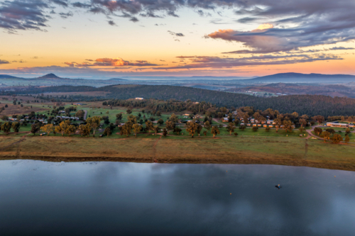 Aerial view at dawn over the expansive waters of Lake Keepit, with a foggy rural landscape. - Australian Stock Image