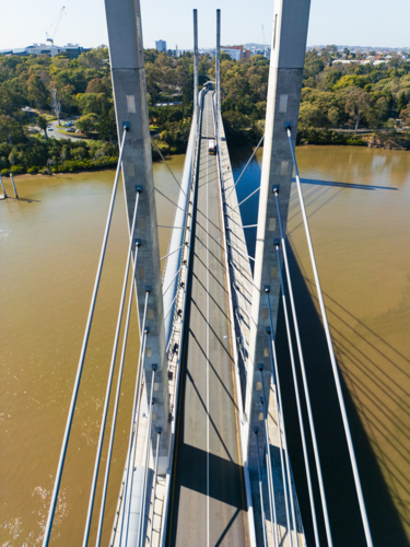 Aerial view between structural pylons of the Eleanor Schonell Bridge looking at the Brisbane River - Australian Stock Image