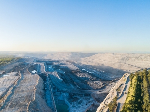 Aerial view looking towards dusty open cut coal mine pit - Australian Stock Image