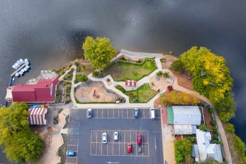 Aerial view of a cafe, car park and barbecue around the shores of a lake - Australian Stock Image
