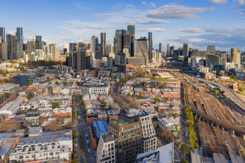 Aerial view of a city skyline and low rise buildings alongside a major railway link at Melbourne - Australian Stock Image