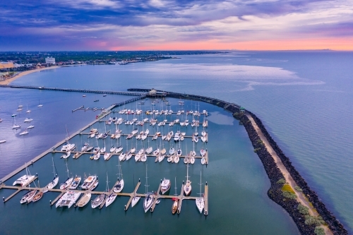 Aerial view of a coastal marina at sunset