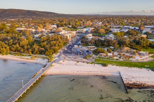 Aerial view of a coastal reserve a the base  of a wooden jetty